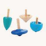 PlanToys Mini Spinning Tops Set of 4 spinning tops in blue shades and natural wood. The spinning tops come in various shapes and are on a cream background