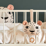 Roommate Musical Baby Mobile - Leopard and Roommate Leopard cushion on a baby cot bed