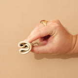 Person demonstrating how to fold a HEVEA LOOP menstrual cup.