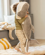 A child holding the Senger giant grey soft and cuddly whale toy showing the size of the toy. This soft toy is available at Babipur.