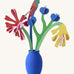 Studio roof small small paper bloom Matisse bouquet with  available at Babipur displayed in a blue vase
