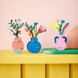 A group of Studio roof 3D pop out card bouquets decoration standing on a yellow wooden table available at Babipur