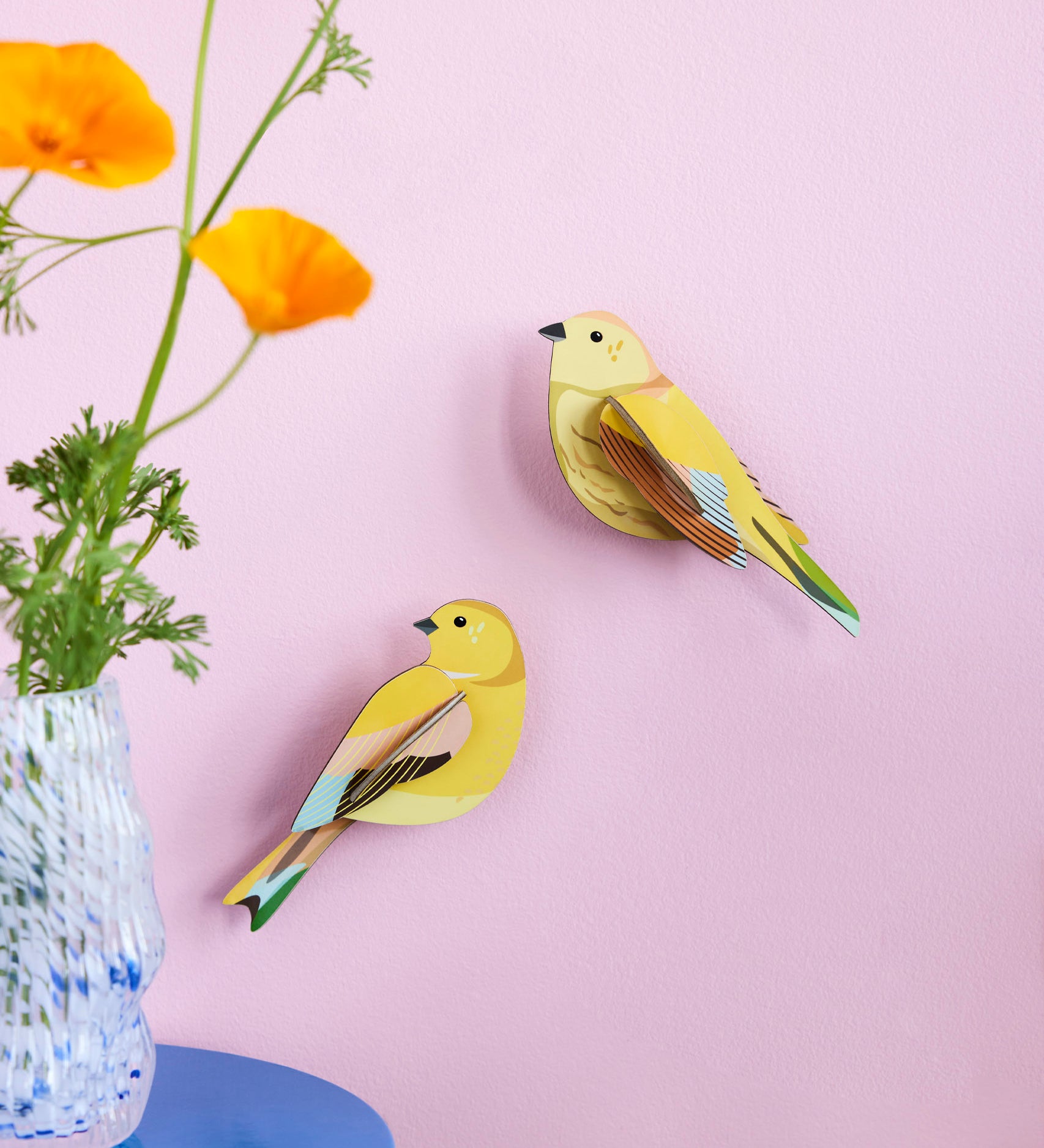 Studio Roof citrinella pair wall decorations available at Babipur hanging on a light purple wall with a glass vase in front