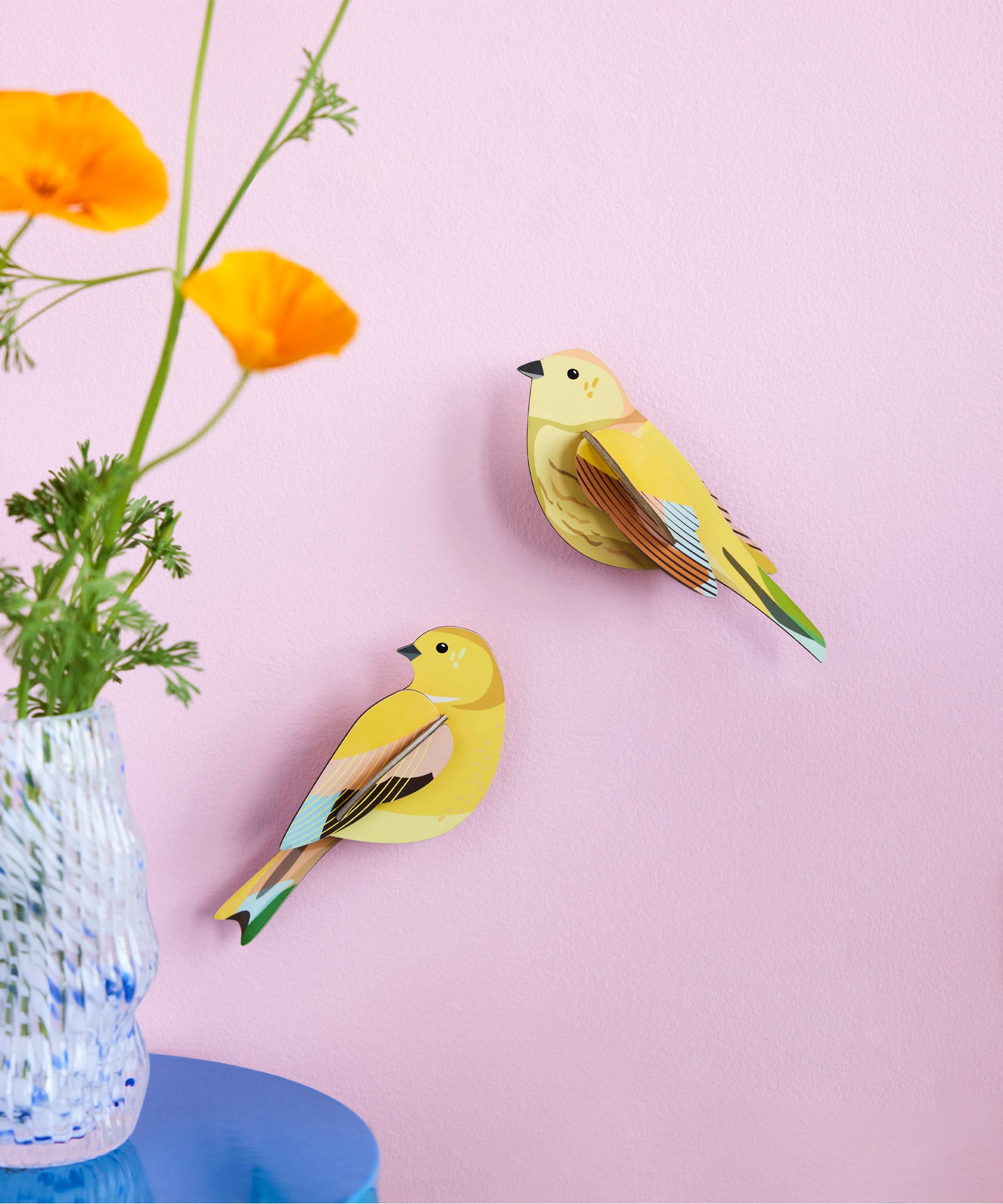 Studio Roof citrinella pair wall decorations available at Babipur hanging on a light purple wall with a glass vase in front