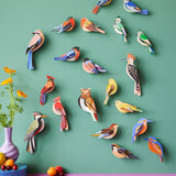 A group of Studio Roof garden birds hanging decorations on a  green wall available at Babipur including the brown tawny owl