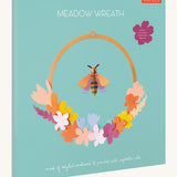 The pastel coloured packaging presenting the Studio Roof wreath meadow with bee available at Babipur.