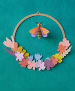 A close up of the Studio Roof wreath meadow with bee available at Babipur. showing the different coloured flowers on the wreath.