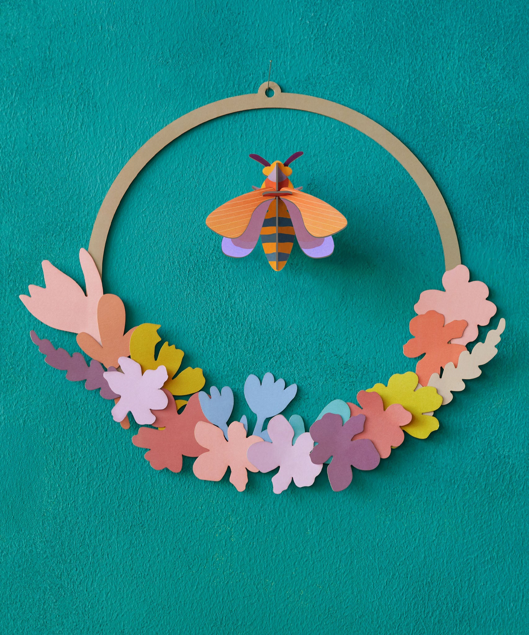 A close up of the Studio Roof wreath meadow with bee available at Babipur. showing the different coloured flowers on the wreath.