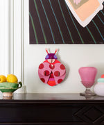 Dotted lady wall decoration available at Babipur hanging on a wall above a mantlepiece. A Studio roof collaboration with artist Zoe Miller.