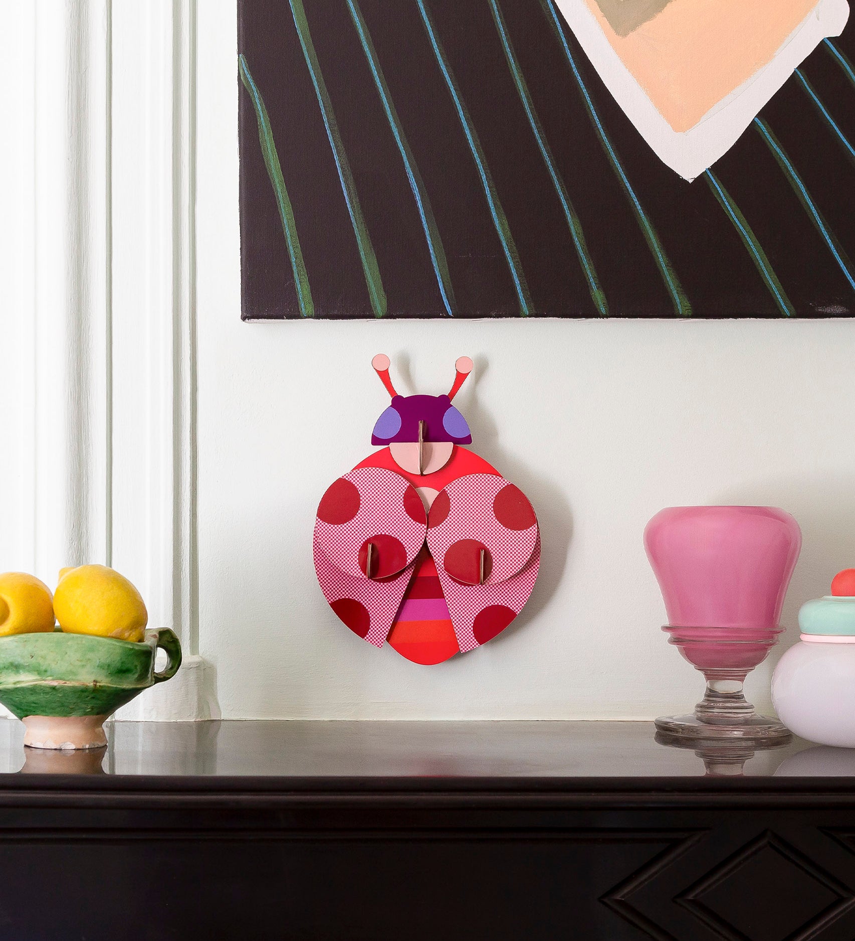Dotted lady wall decoration available at Babipur hanging on a wall above a mantlepiece. A Studio roof collaboration with artist Zoe Miller.
