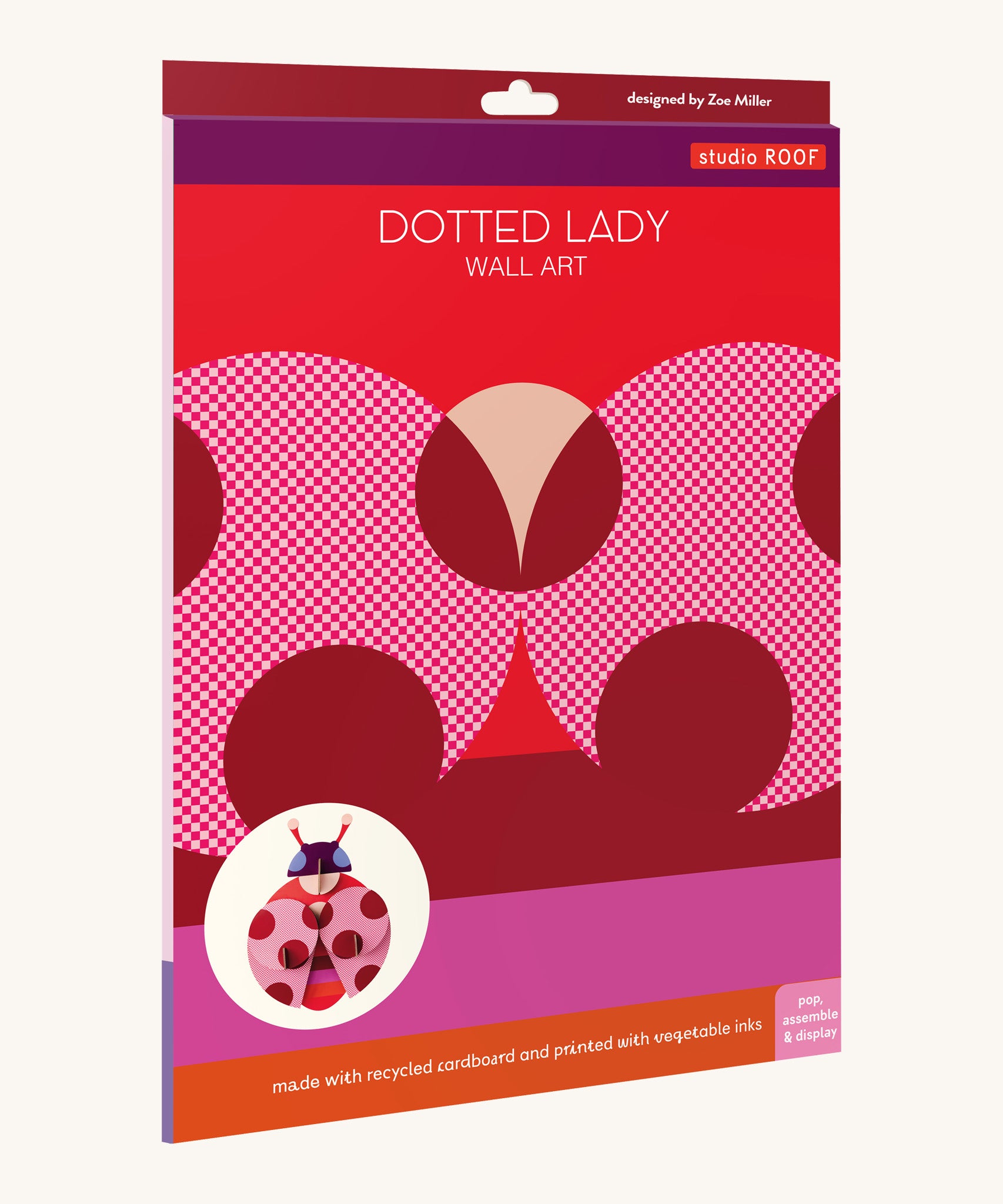 The bright and retro style cardboard packing for the dotted lady wall decoration available at Babipur