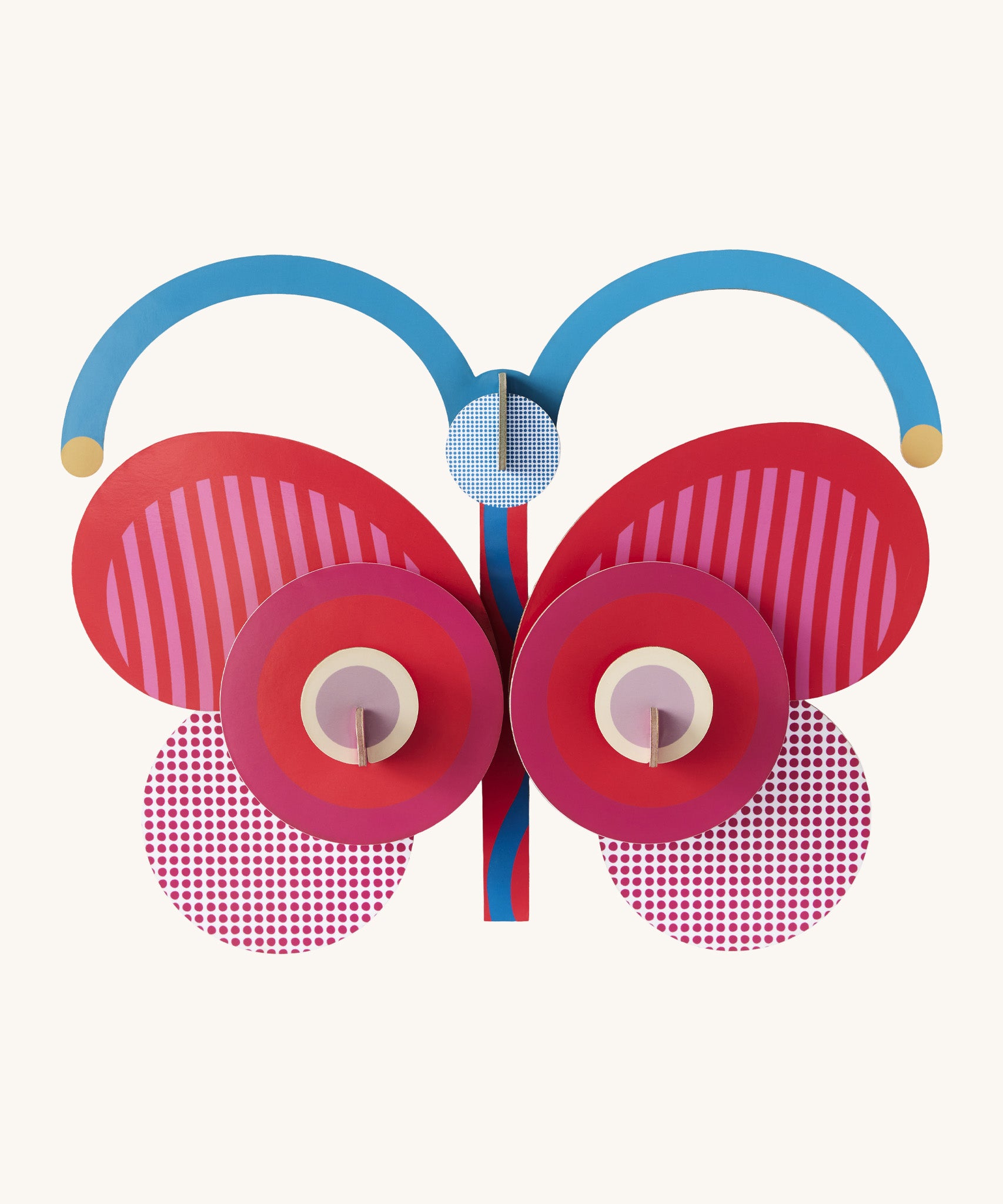A bright and retro style stripy butterfly wall decoration available at Babipur. A Studio roof collaboration with artist Zoe Miller.