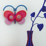 A close up of the Stripy butterfly wall decoration available at Babipur hanging on a wall
