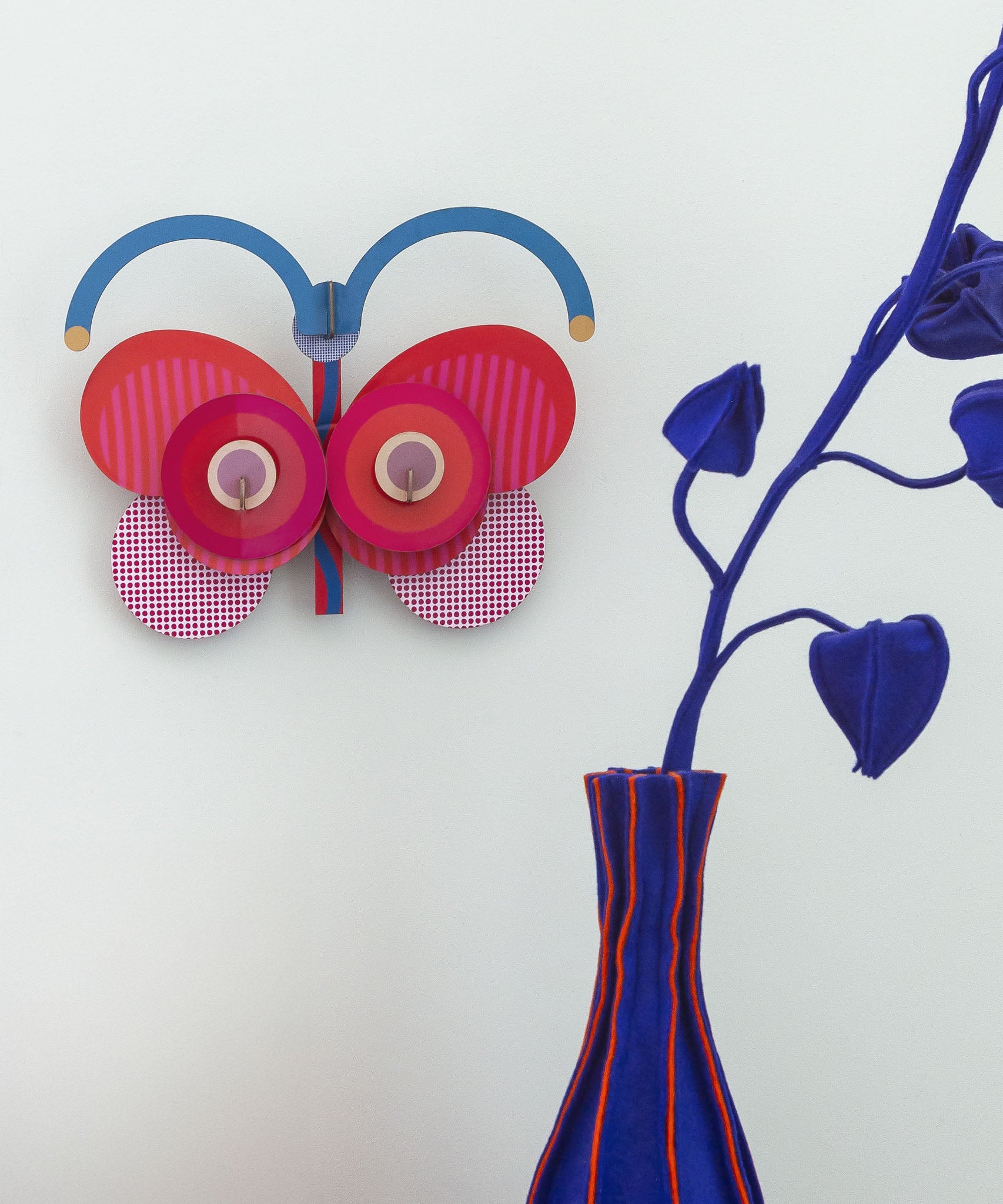 A close up of the Stripy butterfly wall decoration available at Babipur hanging on a wall