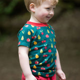 A child happily outside, wearing the LGR Vegetable Patch Short Sleeve T-Shirt
