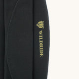 A close up of the Wildride premium shoulder pad in black available at Babipur showing the velcro and brand logo detail