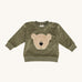 Wooly Organic embroidered sweater in tea leaf /savannah available at Babipur. A soft GOTS organic cotton jersey sweater in light green with a cute fluffy cream teddy bear on the front. Features popper fasteners on the shoulder for a easy fit