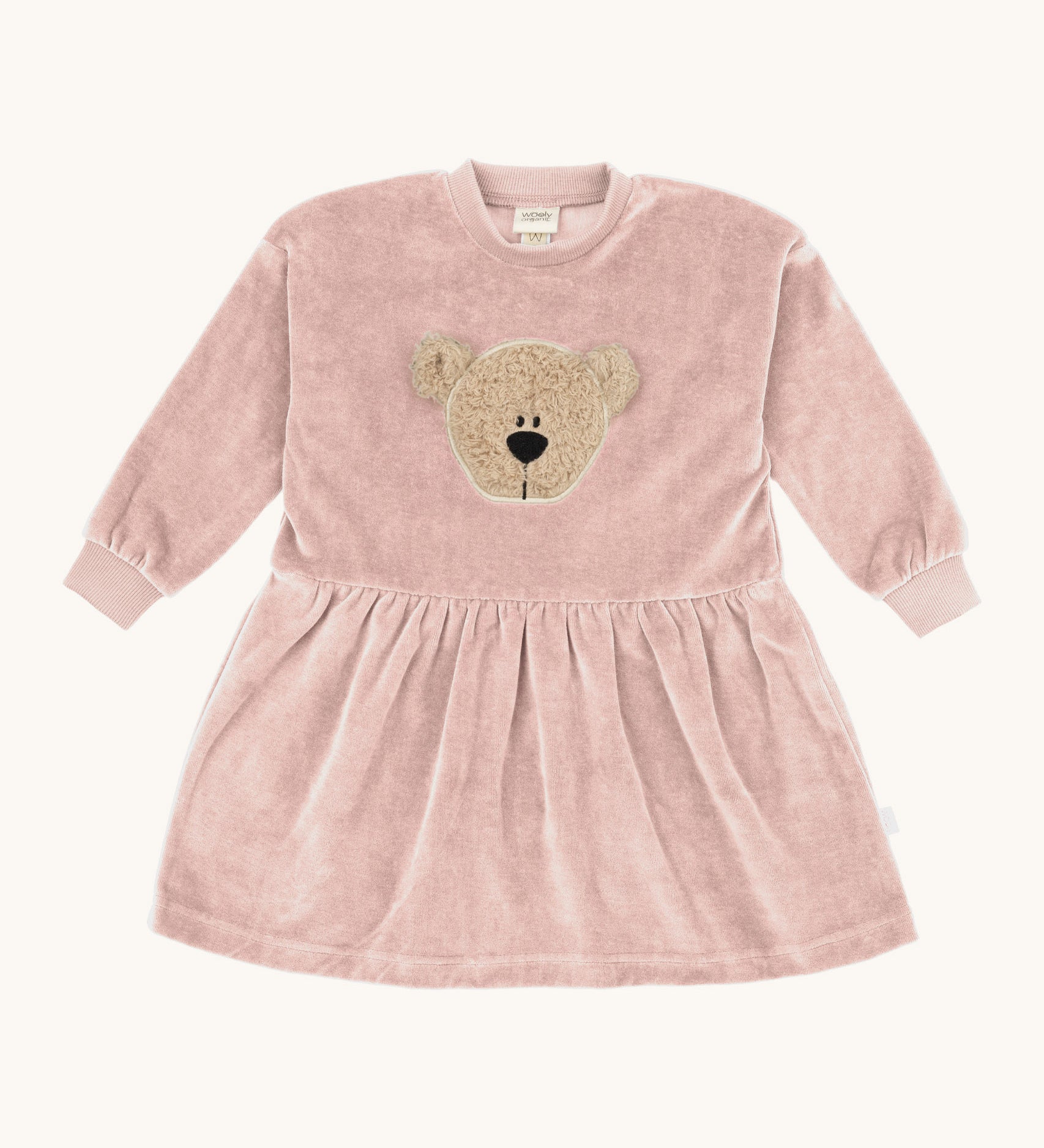 Wooly Organic embroidered velour dress in pale blush pink /savannah available at Babipur. A soft GOTS organic cotton velour sweater in light pink with a cute fluffy cream teddy bear on the front and elasticated arm cuffs