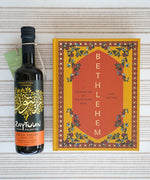 Filled with authentic Palestinian recipes, the Zaytoun Bethlehem Cookbook by Fasi Kattan is a true celebration of the region’s food next to a bottle of Fairtrade Olive Oil — find it at Babipur.
