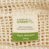 A close up view of the A Slice Of Green small mesh recycled cotton produce bag showing the mesh detail. Features a tag showing the total carry weight and recycled cotton certification