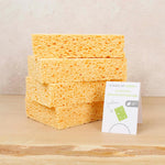 Stack of A Slice of Green natural cellulose cleaning sponges on a wooden worktop