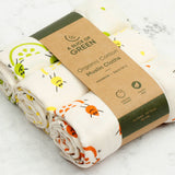 A close up of the A Slice Of Green rainbow muslin cloth set showing the fruit print detail on organic cotton fabric.