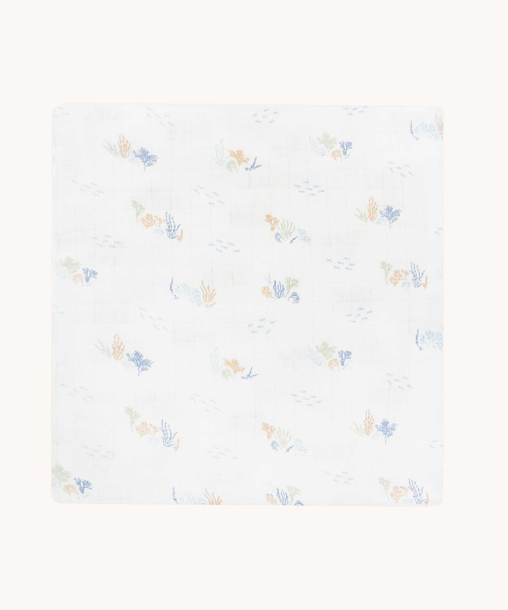 Avery Row Coastline baby Muslin Swaddle. The swaddle features a delicate coastline print that has corals and little blue fish. Avery Row have a collection of stylish nursery and baby essentials available at Babipur.