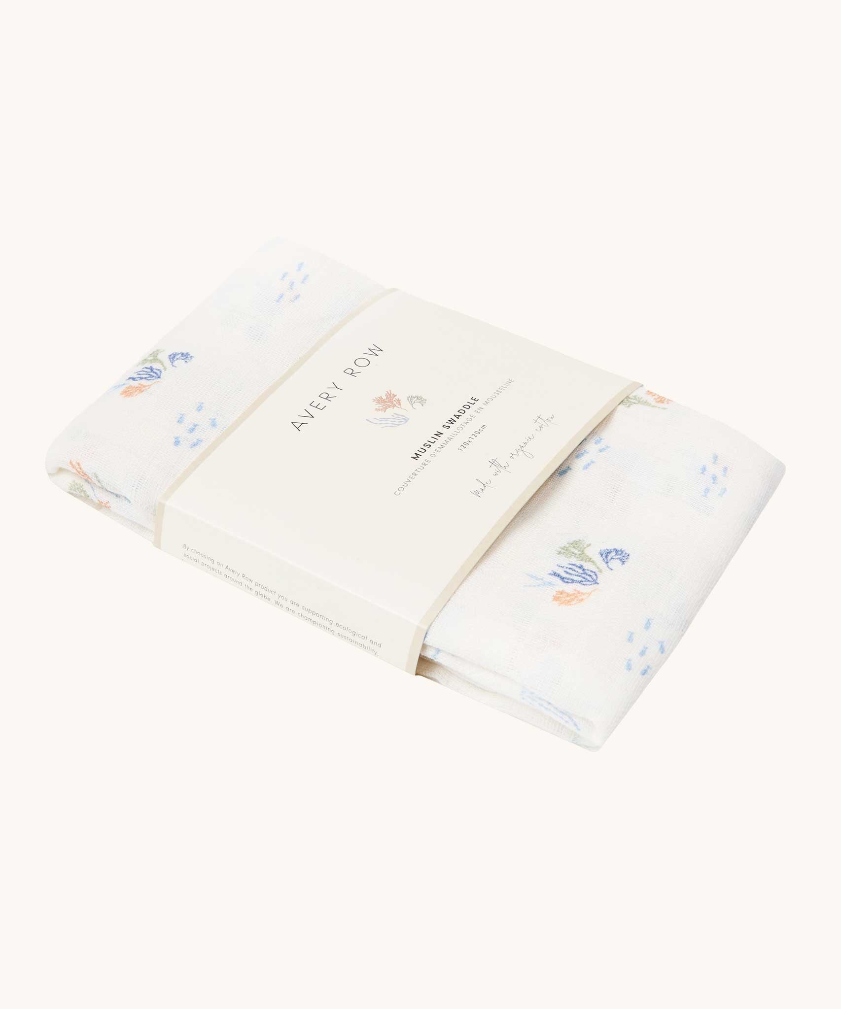 Avery Row Coastline baby Muslin Swaddle. The swaddle features a delicate coastline print that has corals and little blue fish. Avery Row have a collection of stylish nursery and baby essentials available at Babipur.