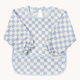 Avery Row Sleeved Bib with a check Waves design. This blue and white coloured bib has long sleeves with elasticated cuffs and features a pocket to help catch any food debris. We have a wide range of Avery Row stylish baby products available at Babipur.