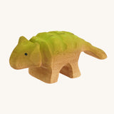 Green and light brown baby standing Akylosaurus on a cream background