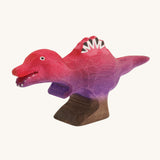 Pink and purple standing baby spinosaurus on a cream background