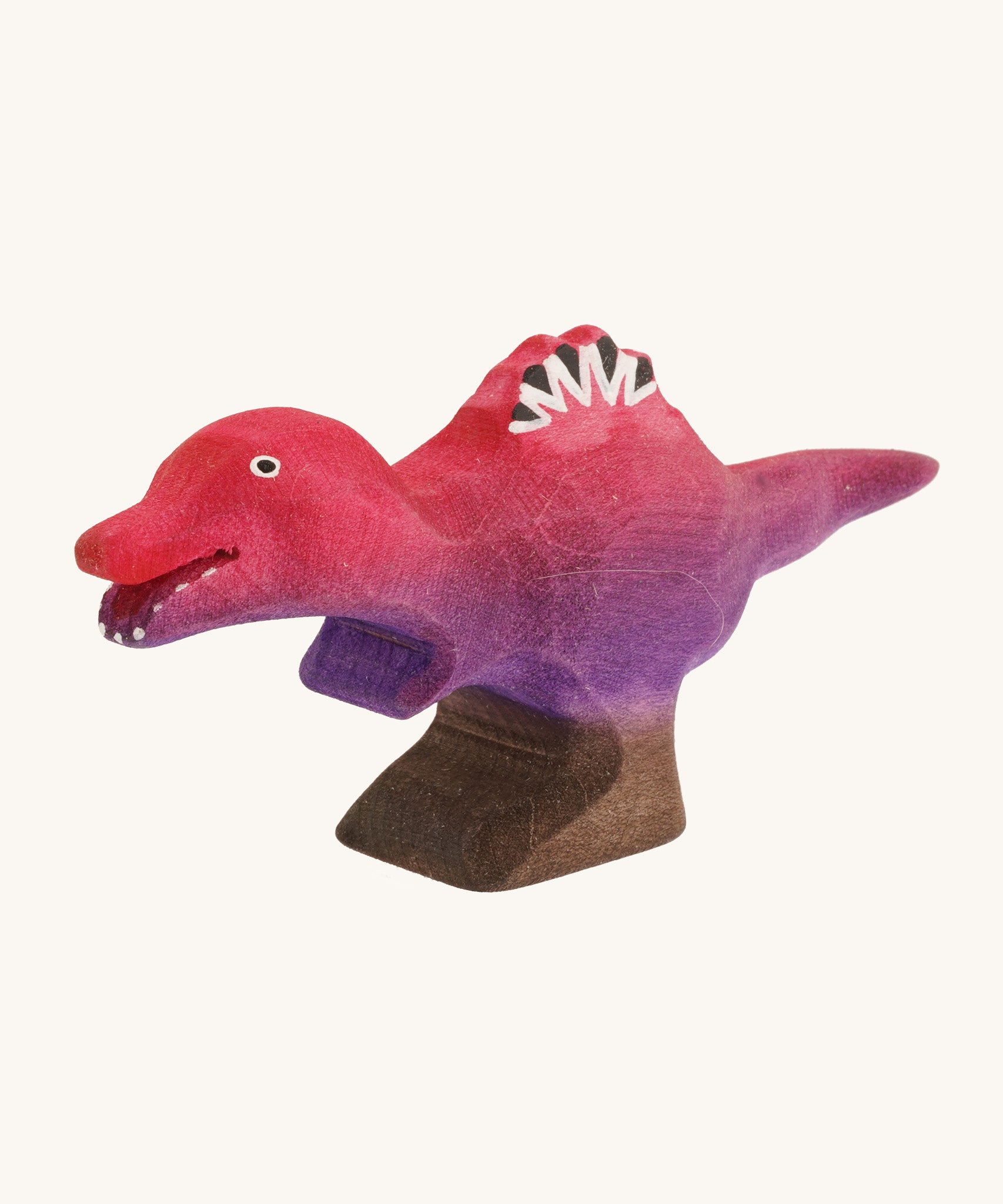 Pink and purple standing baby spinosaurus on a cream background