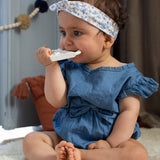 A child on a light grey sofa