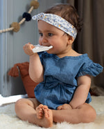 A child on a light grey sofa