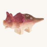 Light and dark brown with spots standing baby triceratop on a cream background