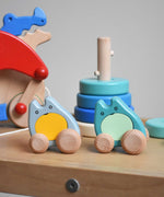 Two Bajo wooden push along ghost toy placed on Triclimb Miri slide with other Bajo toys behind them.
These heirloom quality wooden toys are part of a wide range available here at Babipur.