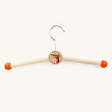 A wooden fox gruffalo character kids hanger on a cream backround