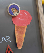 A close up of a Bajo gruffalo owl magnet stuck onto a Triclimb biri board. These magnets are part of a range of Bajo wooden toys available at Babipur.