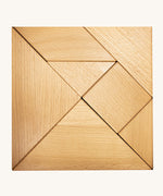 Bajo tangram puzzle set showing 7 natural wooden pieces in different geometric shapes