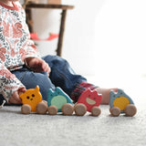 A child sitting on the floor with four Bajo wooden push along ghost toys placed in front of them.
These heirloom quality wooden toys are part of a wide range available here at Babipur.