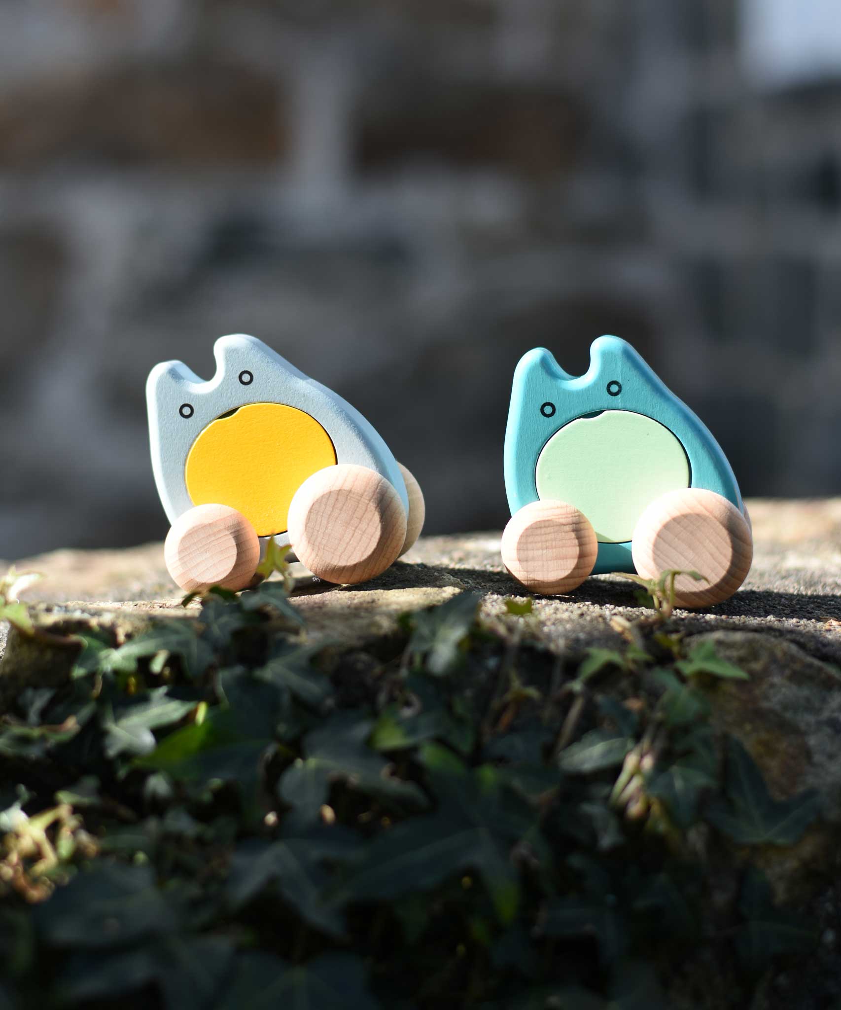 Two Bajo wooden push along ghost toys placed on a stone wall outdoors.
These heirloom quality wooden toys are part of a wide range available here at Babipur.