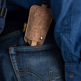 The Bambu Bamboo Utensil Travel Set with Cork Fabric Pouch shown in a person's back pocket of a pair of denim jeans