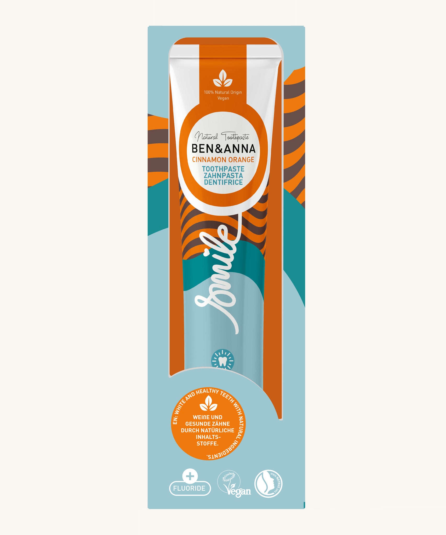 Ben & Anna orange and cinnamon toothpaste showing a orange stripes with blue waves design on the packaging with a playful smile slogan in white in the middle