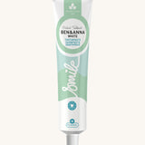 Ben & Anna certified 100% natural white toothpaste showing a green wave design on the tube with a playful smile slogan in white in the middle.