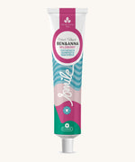 Ben & Anna Certified 100% natural toothpaste in wild berry flavour. Showing a blue stripe with pink and green wave design on the tube. Features a playful smile slogan in white in the middle.
