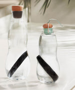 2 glass bottles with the Black + Blum charcoal filters with coil inside