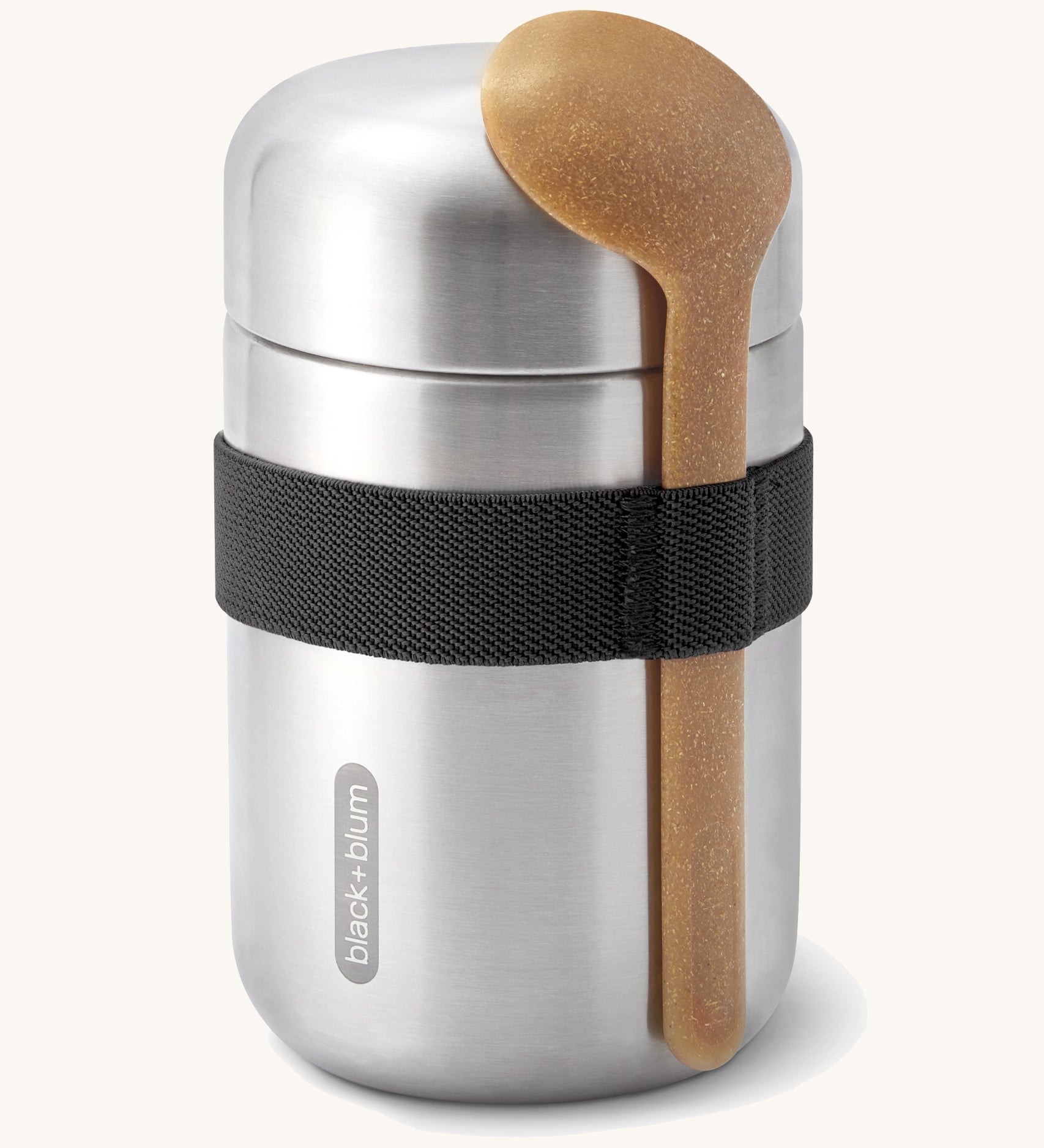 Black + Blum insulated stainless steel food flask with a wooden spoon available at Babipur. Features a black elastic strap to hold the spoon