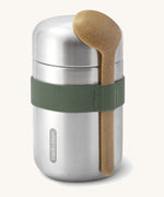 Black + Blum insulated stainless steel food flask with a wooden spoon available at Babipur. Features a olive green elastic strap to hold the spoon