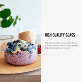 The glass bowl from the Black+Blum Leakproof Microwave Safe Glass Lunch Bowl shown filled with food. The text alongside reads, High quality glass. The glass in the lunch bowl is Borosilicate, which is lightweight, stain resistant and strong.