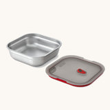 A close up of a Black + Blum square stainless steel leakproof microwave safe lunchbox showing the lid detail